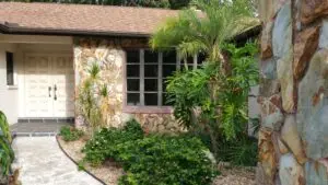 FRONT OF A HOUSE WITH TROPICAL SCRUB